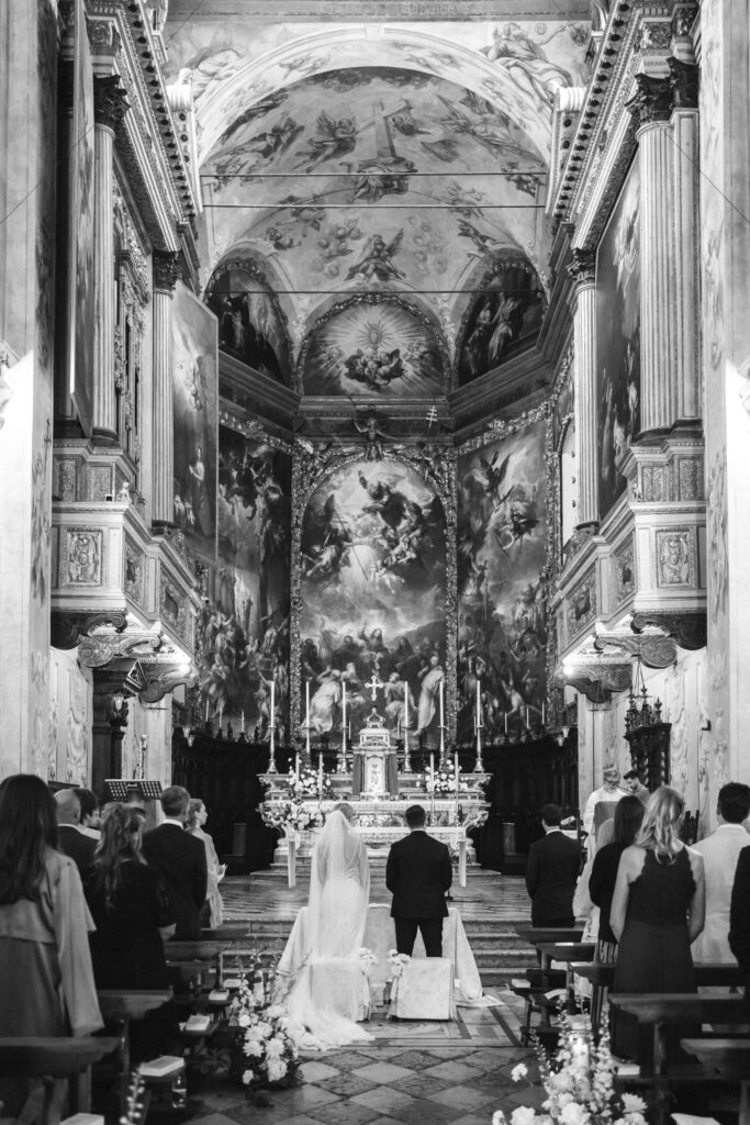 Brautpaar vor dem Altar in einer prunkvollen Kirche am Gardasee in Italien.